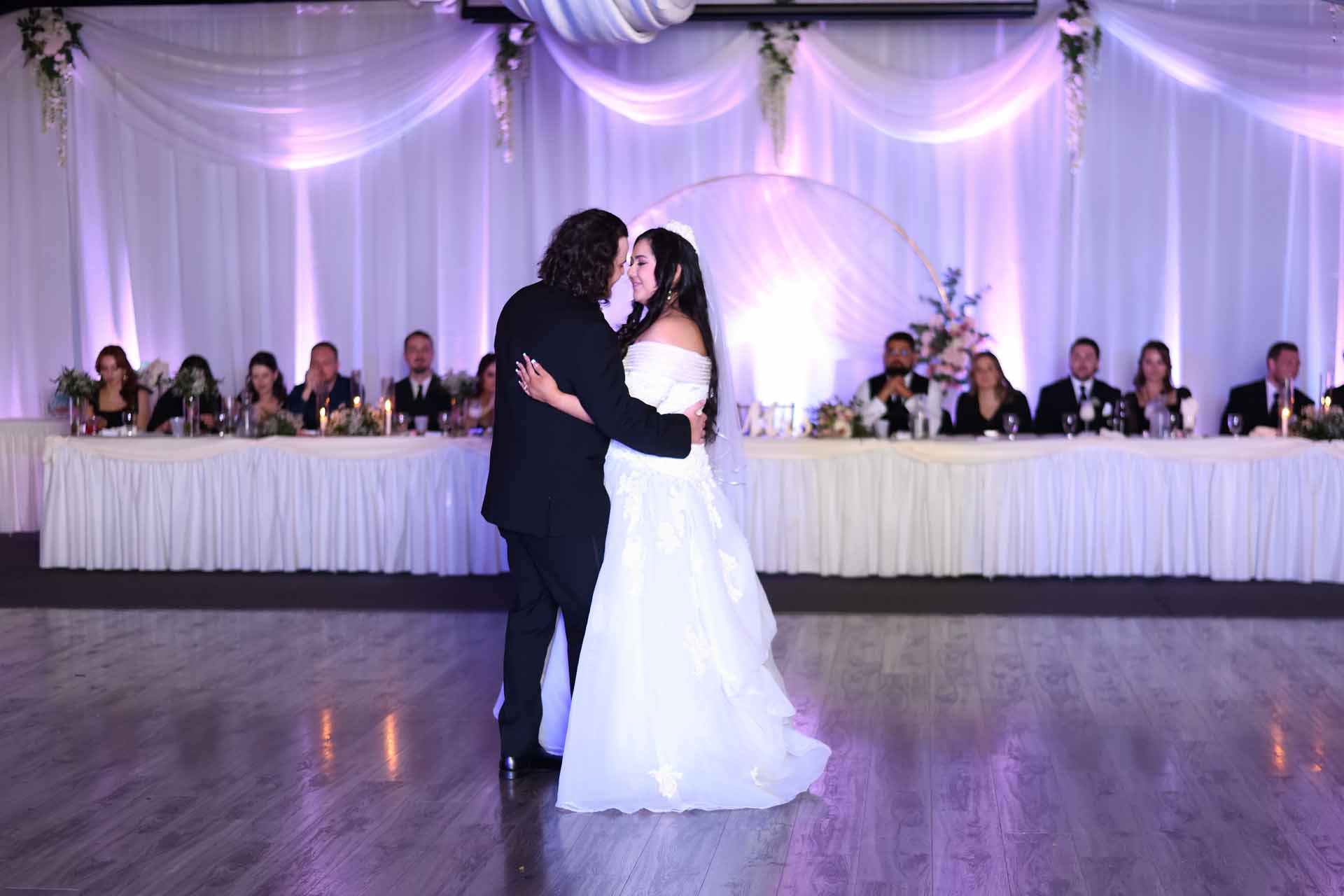 Bride and groom dancing at wedding reception.