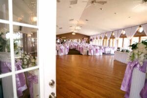 Wedding reception hall with decorated tables.